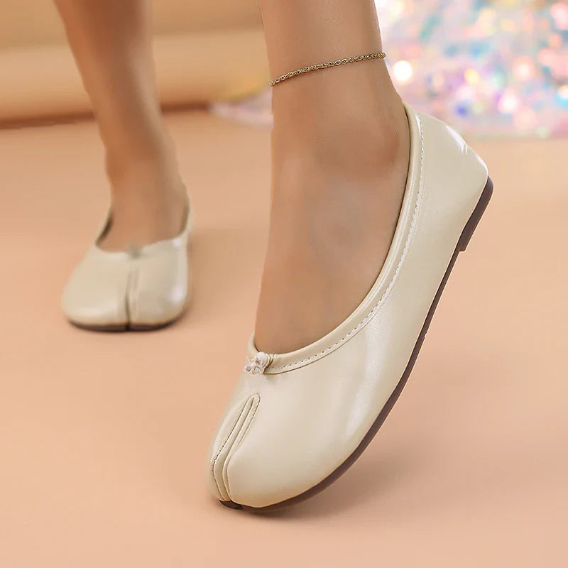 Women's minimalist split toe flats, made from soft faux leather for comfort.