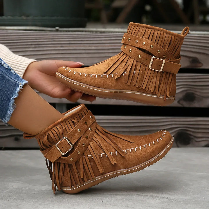 Textured suede-like finish on women's black fringe ankle boots with studded buckle
