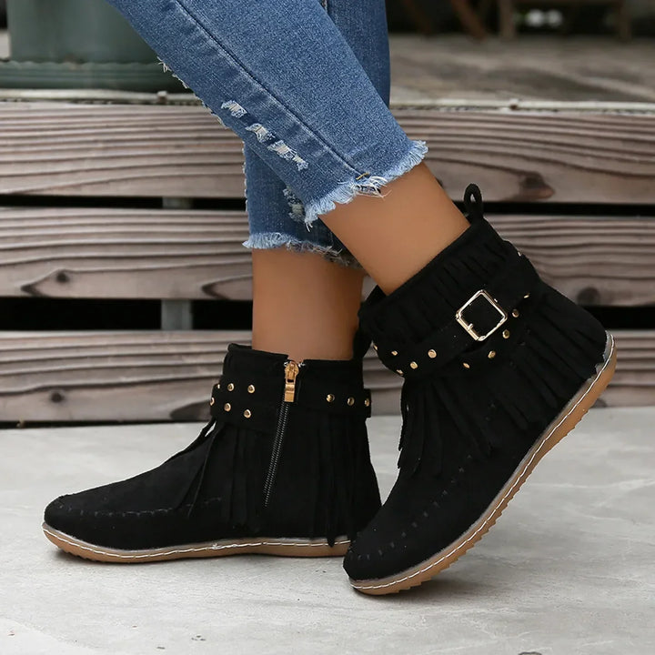 Front view of women's black fringe ankle boots, featuring stylish studded buckle element