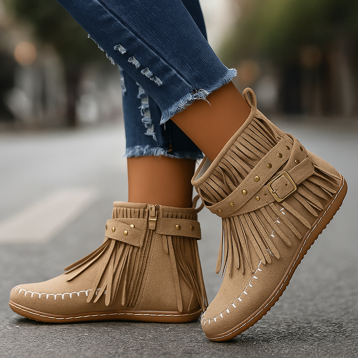 Pair of women's black suede-like fringe ankle boots, casual fashion footwear