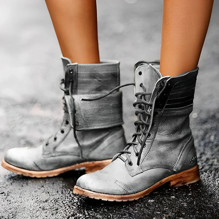Close-up of women's rugged lace-up ankle boots, showing textured material and sturdy construction