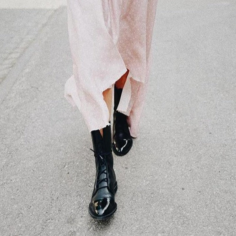 Stylish women's black combat boots, lace-up front, sturdy construction for everyday wear.