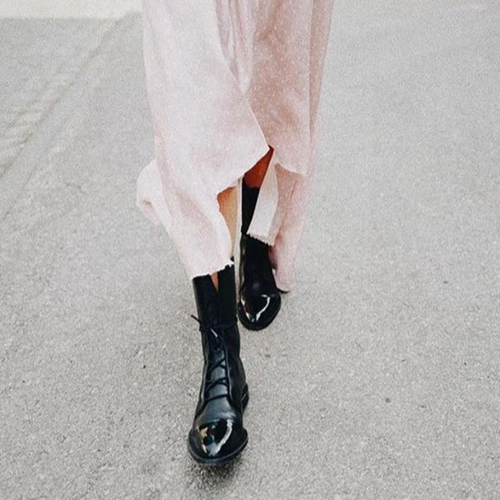 Stylish women's black combat boots, lace-up front, sturdy construction for everyday wear.