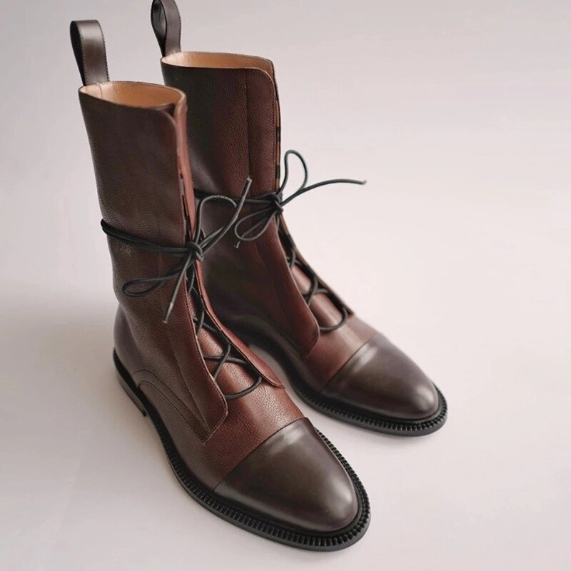 Pair of women's combat style ankle boots in a rich brown, ideal for autumn fashion.
