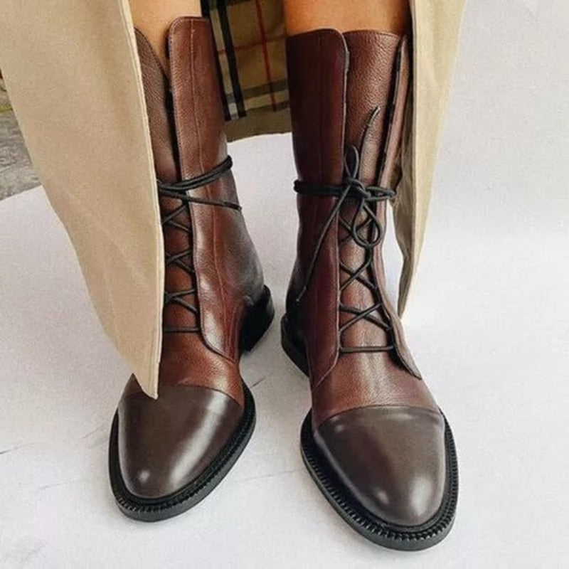 Fashionable women's lace-up boots in black, classic combat design for versatile outfitting.