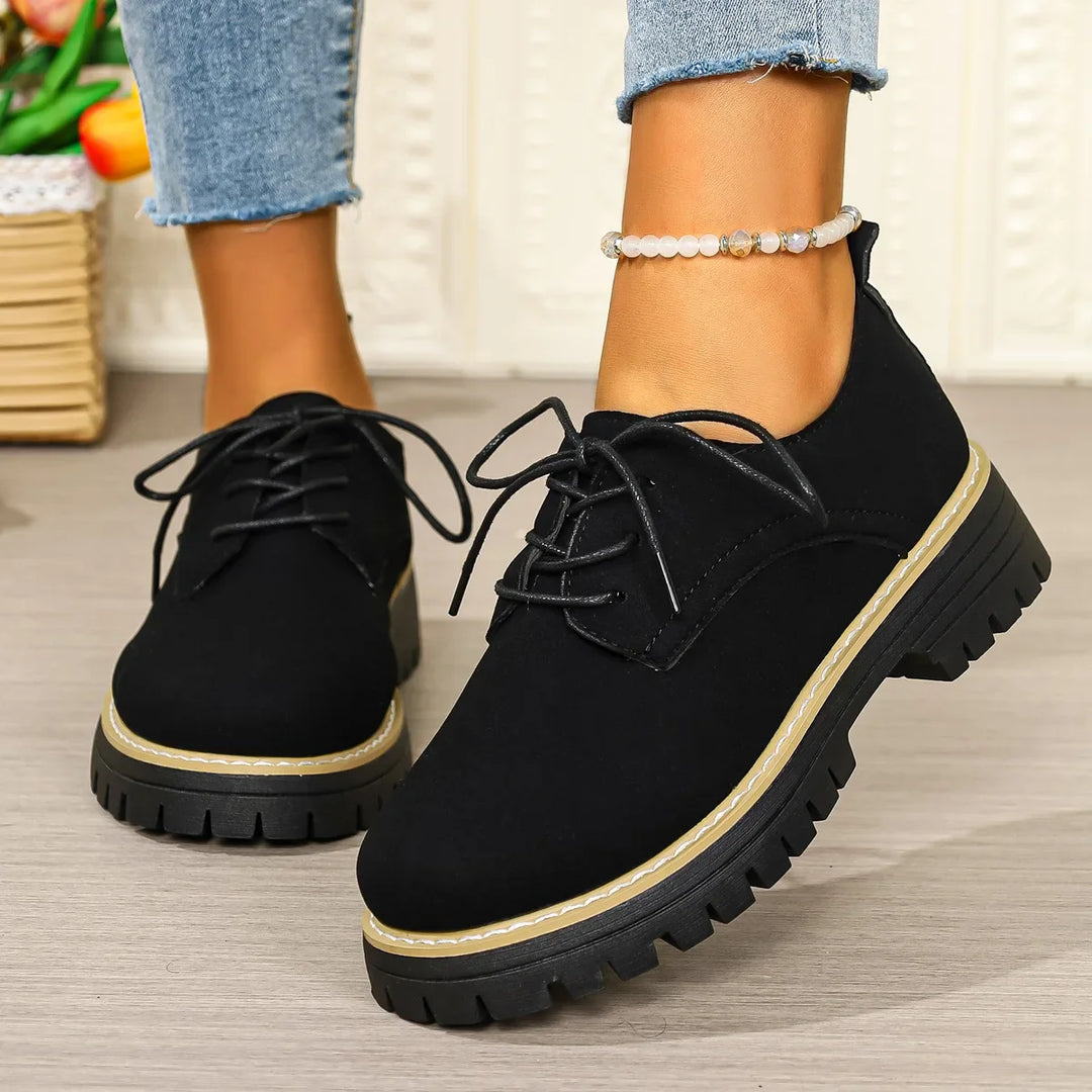 Fashionable women's platform shoes featuring a comfortable design and versatile lace-up style in black.