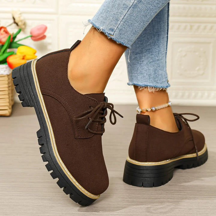 Stylish women's black platform shoes, ideal for everyday fashion, with a durable chunky sole and lace-up front.