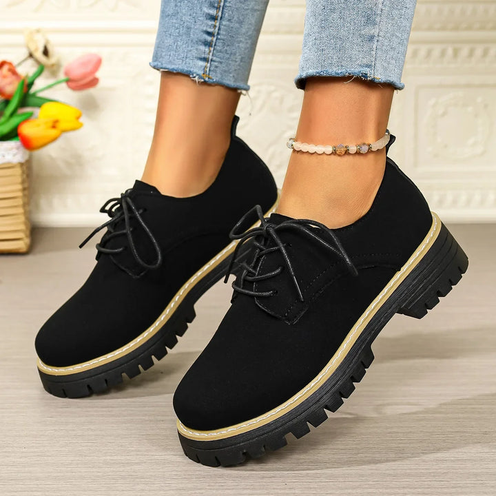 Comfortable women's black platform shoes with a trendy lace-up design and suede-like texture, versatile footwear.