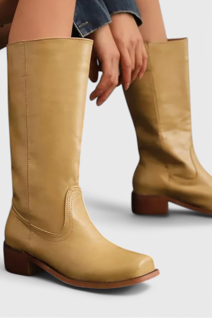 Women's black leather knee-high boots with a block heel, elegant and versatile for fall fashion.
