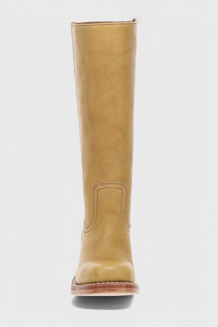 Women's leather knee-high boots displayed on a clean background, highlighting their elegance.