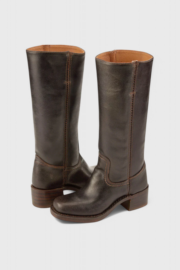 Side view of women's fall fashion leather knee-high boots with a sturdy heel.