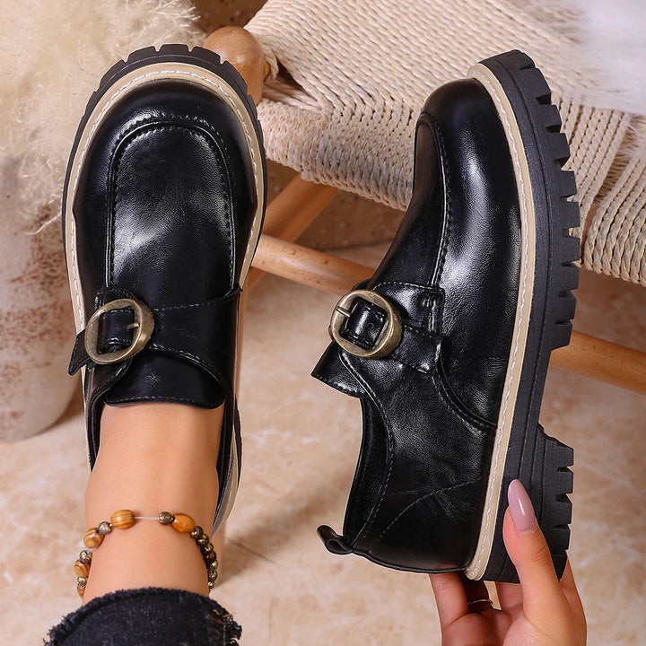 Stylish women's black leather loafers, versatile for both casual outings and office attire.