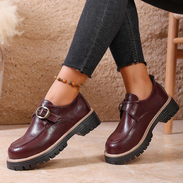 Elegant women's dress loafers in leather with a sophisticated buckle embellishment.