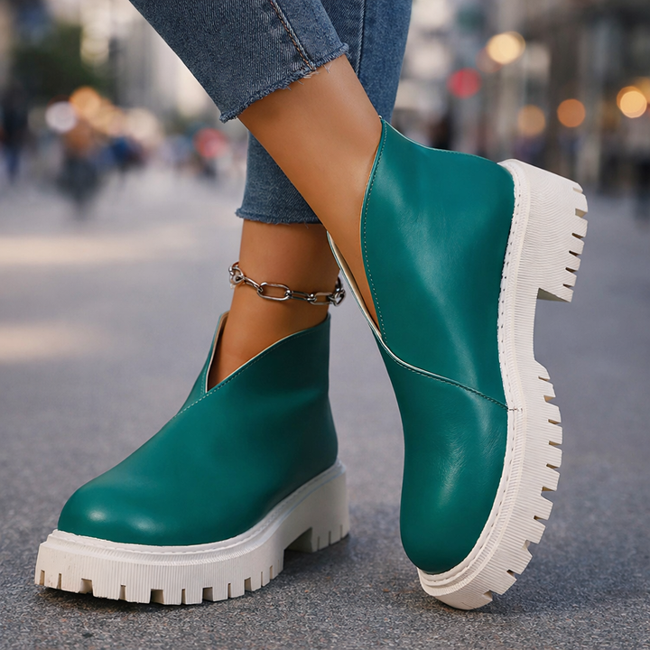 Women's black leather platform slip-on shoes, modern casual footwear for comfort.