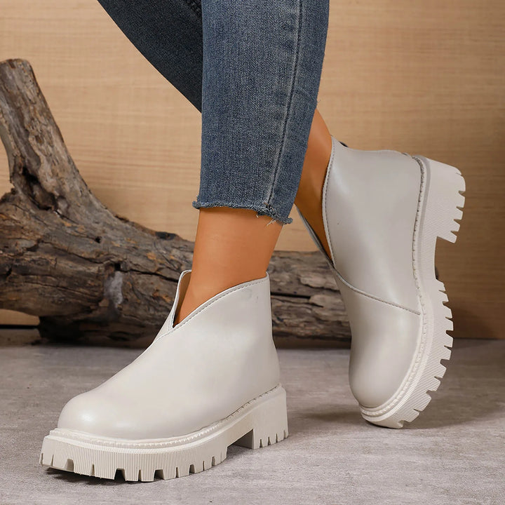 Elegant women's leather slip-on shoes with a subtle platform, ideal for modern fashion.