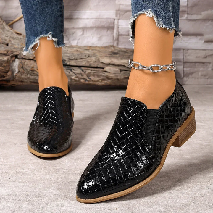 Side view of women's fashion ankle boots, showcasing the woven leather and easy slip-on access.