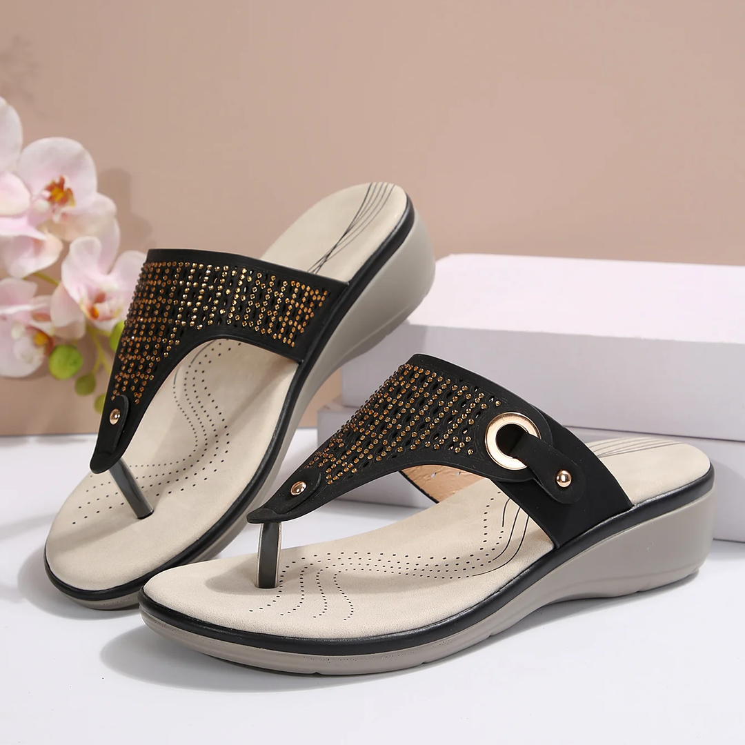 Side view of slip-on women's sandals, showcasing orthopedic arch support in black