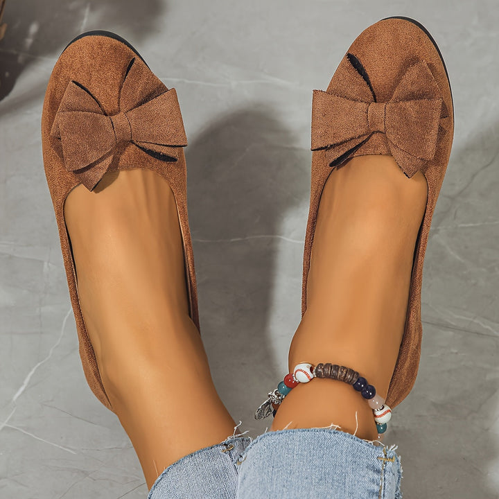 Women's black orthopedic low heel flats, elegant comfort footwear.