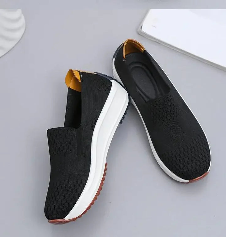 Women's white orthopedic slip-on walking shoes modeled in motion, showcasing lightweight feel