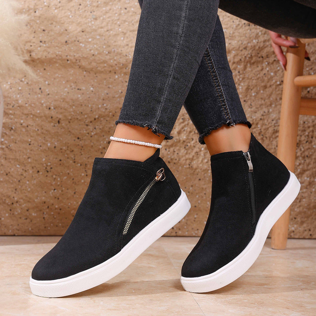 Close-up of women's orthopedic zip-up sneakers, highlighting the front zipper for easy on/off.