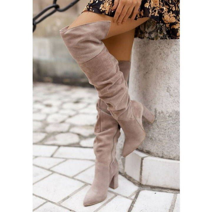 Stylish women's over-the-knee block heel boots in black, featuring a pointed toe and dressy design