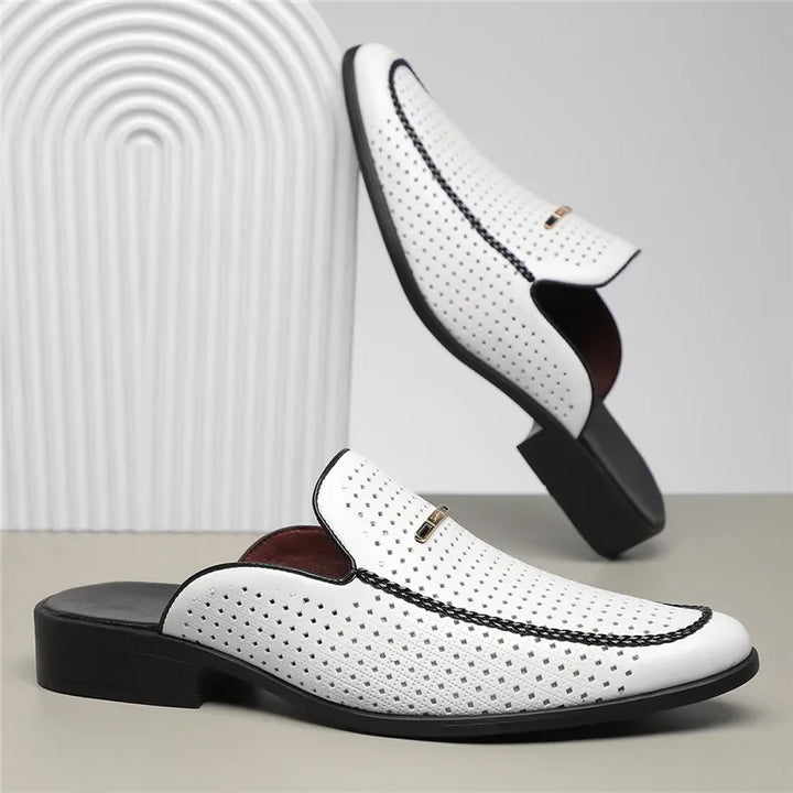 Side profile of a women's perforated leather mule, demonstrating its ergonomic design