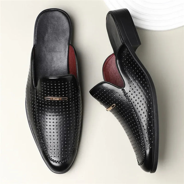 Front view of women's perforated leather mules, highlighting the sleek slip-on style