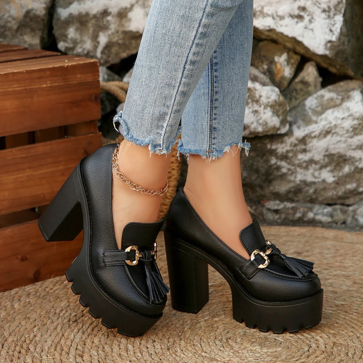 Fashion footwear: burgundy platform loafers with a chunky heel and classic tassel embellishment.