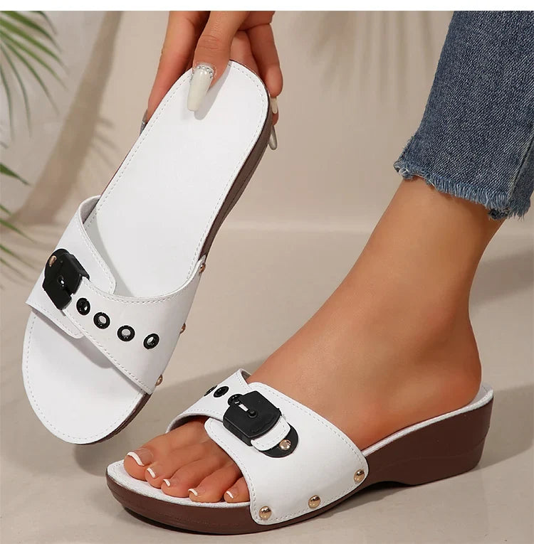 Side view of a women's wine platform wedge slip-on sandal, showcasing design