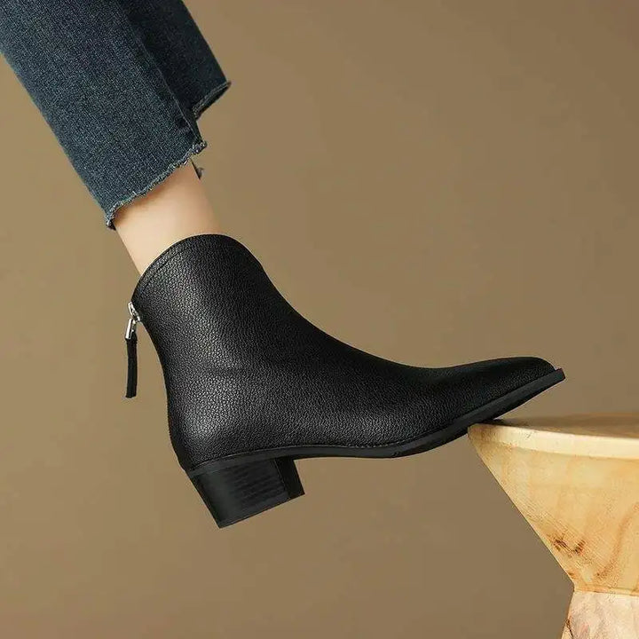 Black women's pointed toe ankle boots, low block heel, easy slip-on professional footwear.
