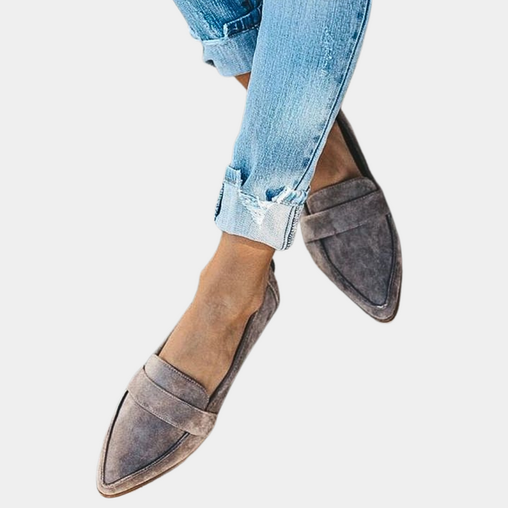 Women's black pointed-toe slip-on loafers. Stylish flats for versatile everyday comfort and elegant casual wear.