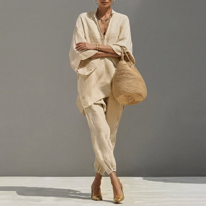 Beige women's two-piece set featuring a relaxed tunic and tapered pants, ideal for travel wear & casual elegance.