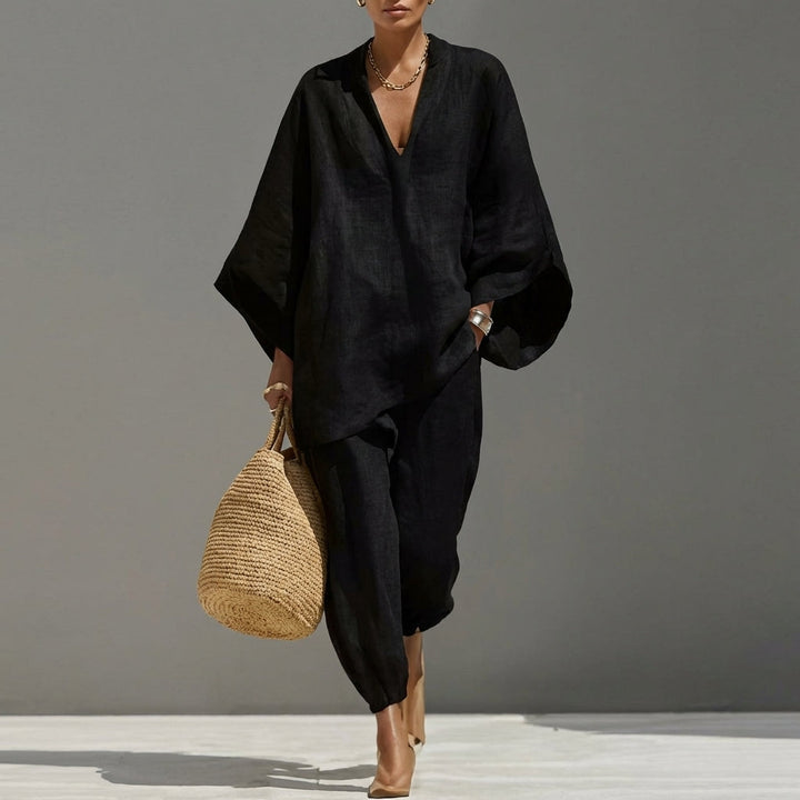 Stylish women's relaxed fit tunic and tapered pant set in black, offering everyday elegance and comfort.