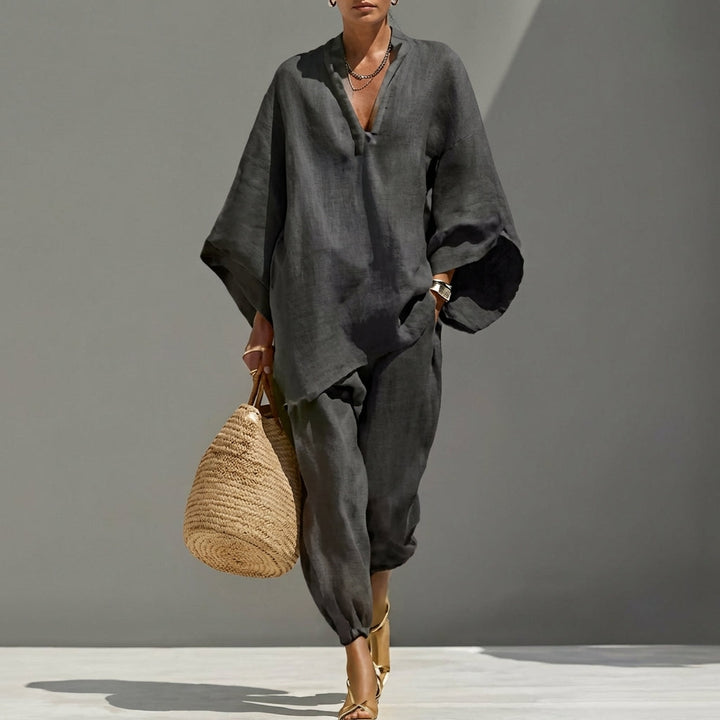 Comfortable beige women's loungewear set with an oversized tunic top & flattering tapered pants for relaxation.