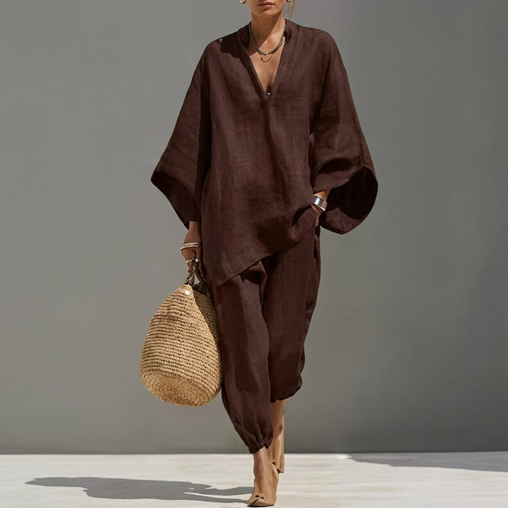 Elegant women's two-piece set in beige, featuring a relaxed tunic and tapered pants for versatile stylish comfort.