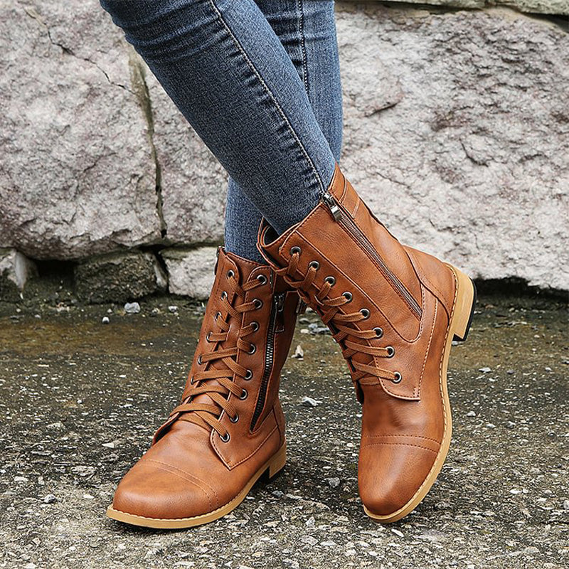 Side profile of women's black combat boots with side-zip, fashion footwear
