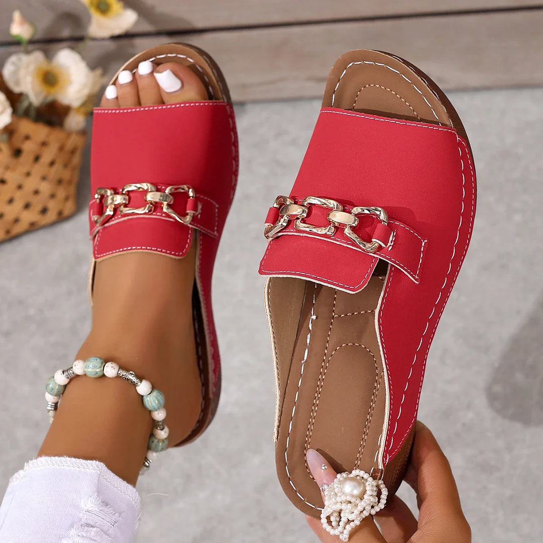 Black slide sandals with chain detail, designed for ultimate comfort and style