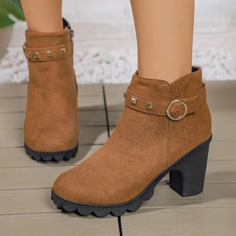Side view of women's black studded block heel fashion boots on a white background