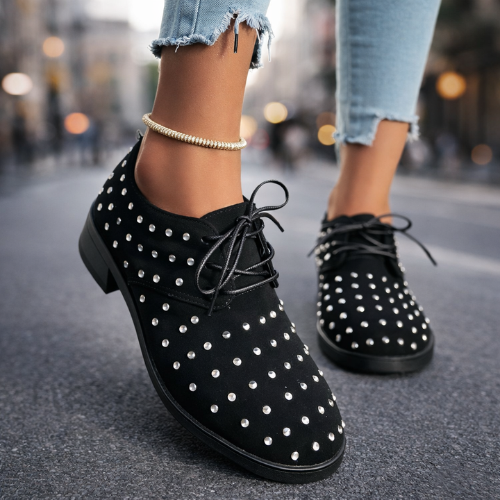 Close-up of women's fashion oxford shoes featuring stud details and practical lace-up closure for comfort.