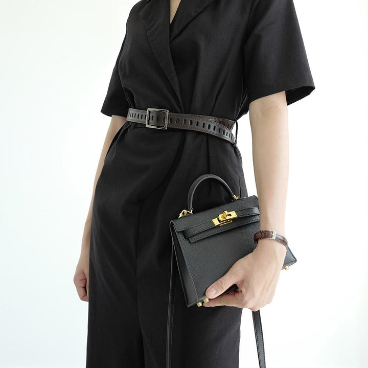Structured women's top handle crossbody bag. Use as a shoulder bag or handbag. Elegant turn lock. Versatile fashion accessory.