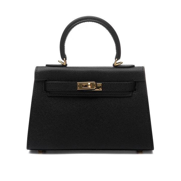 Elegant women's vegan leather crossbody bag. Top handle & shoulder strap, secure turn lock. Structured fashion accessory.