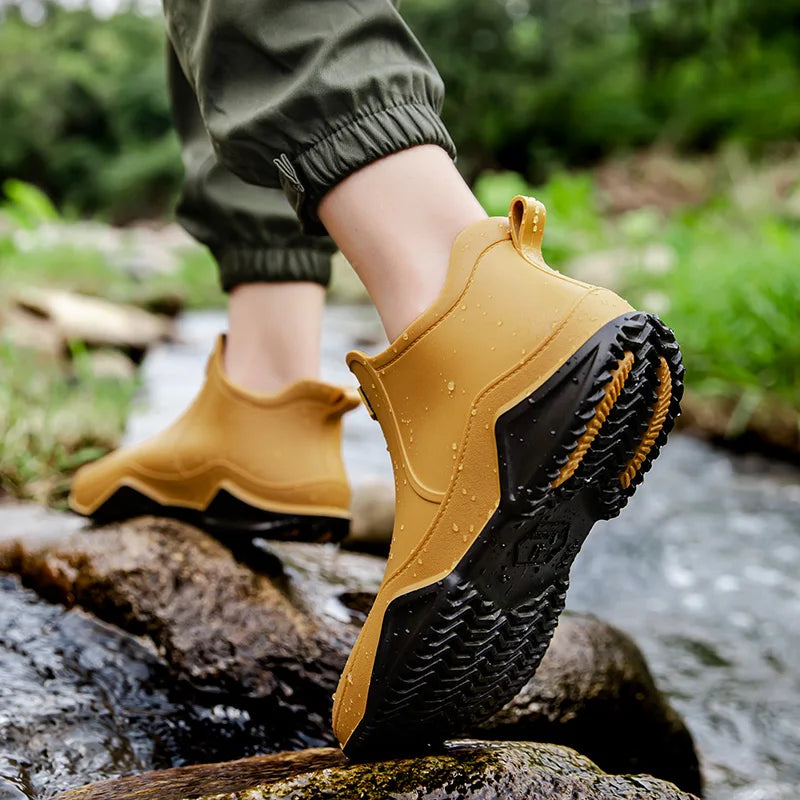 Stylish women's black waterproof slip-on ankle rain boots, combining fashion with practical wet weather wear.