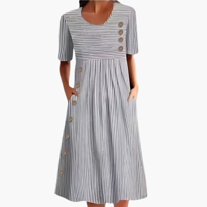 Stylish women's blue striped midi dress. Loose fit, 3/4 sleeves, round neck. Comfortable and chic for casual or work wear.