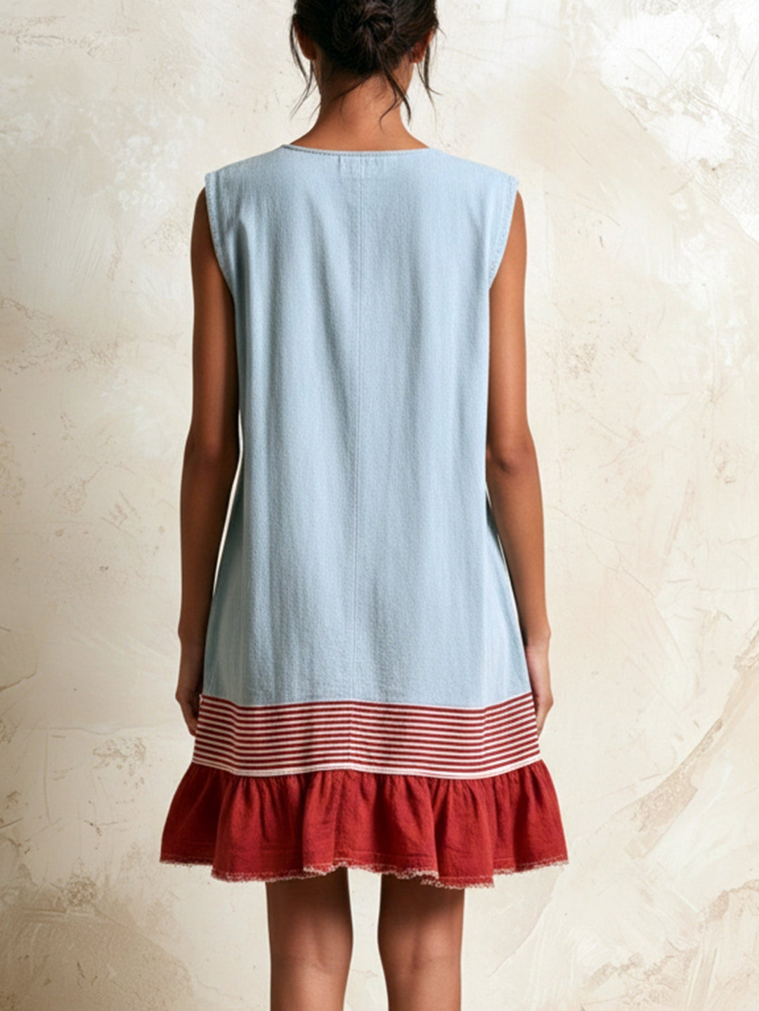 Sleeveless blue tiered ruffle mini dress, ideal for boho summer fashion or a vacation outfit.