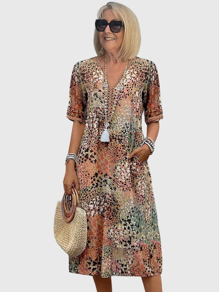Women's bohemian abstract print V-neck midi dress with flutter sleeves, perfect for summer casual wear.