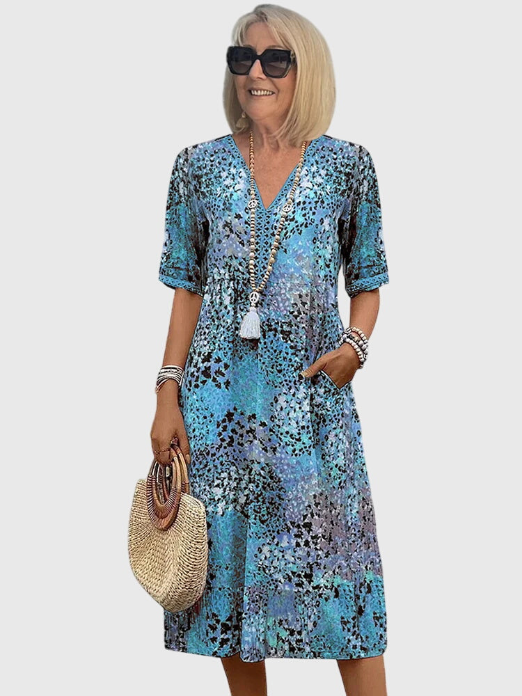 Casual summer midi dress with a comfortable V-neck and unique abstract print, ideal for warm weather.