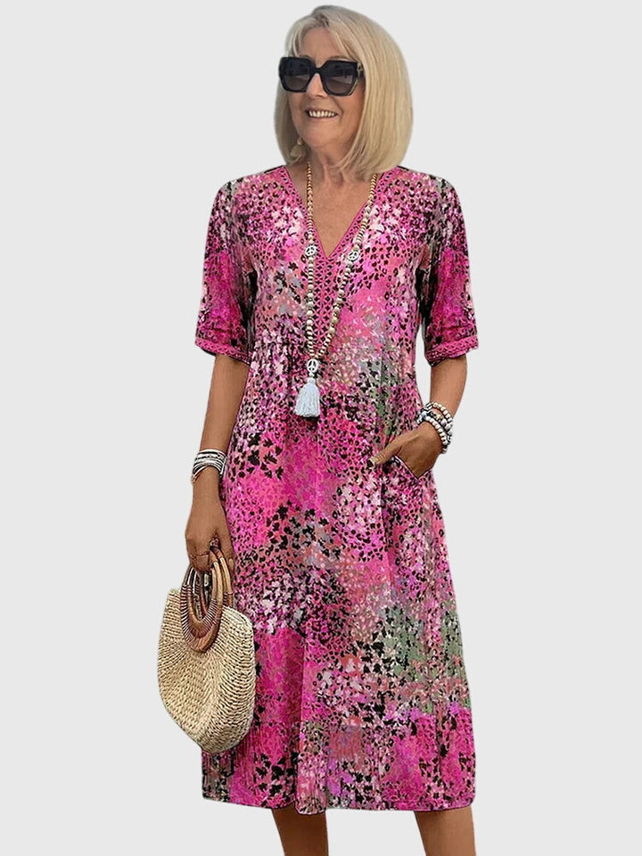 Bohemian women's midi dress with flutter sleeves and a flattering V-neck, showcasing an abstract pattern.