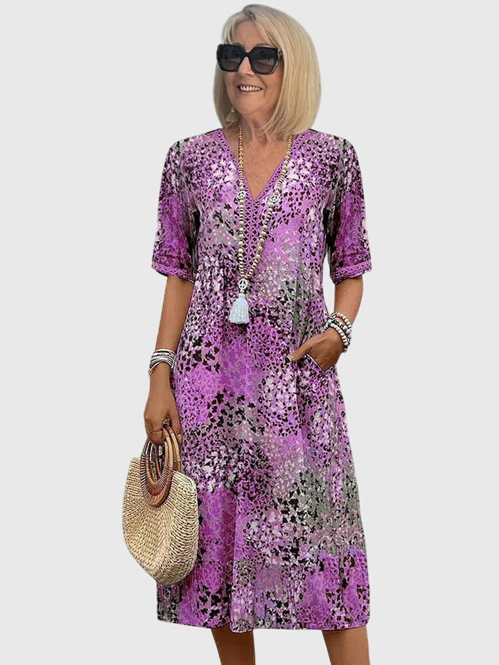 Stylish women's abstract print boho midi dress with V-neckline and flowy design for a chic summer look.
