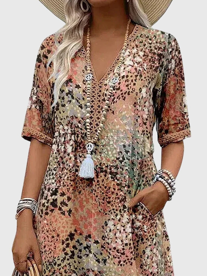 Vibrant abstract print women's boho midi dress, featuring a V-neck and flutter sleeves for summer comfort.
