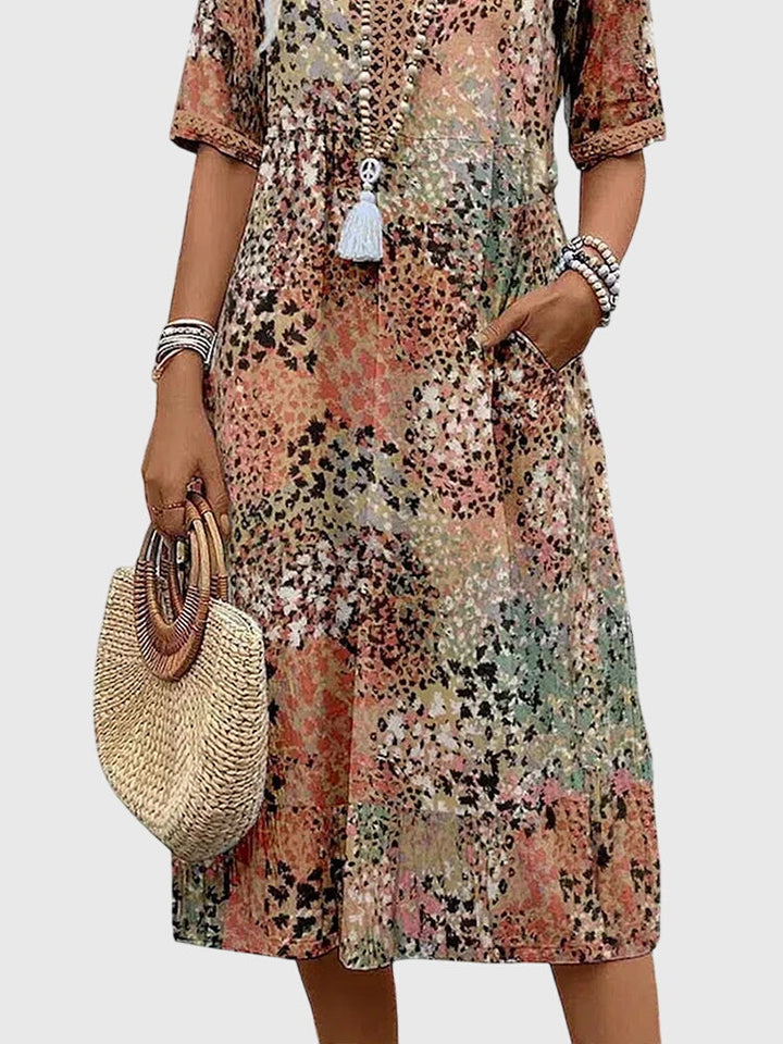 Elegant abstract print midi dress for women, with a V-neck, flutter sleeves, perfect for bohemian summer style.